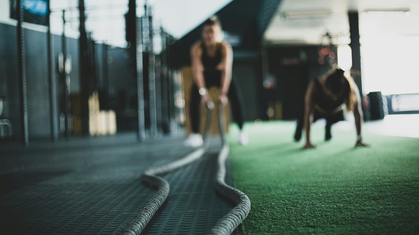 Personal trainer coaching a client in the gym