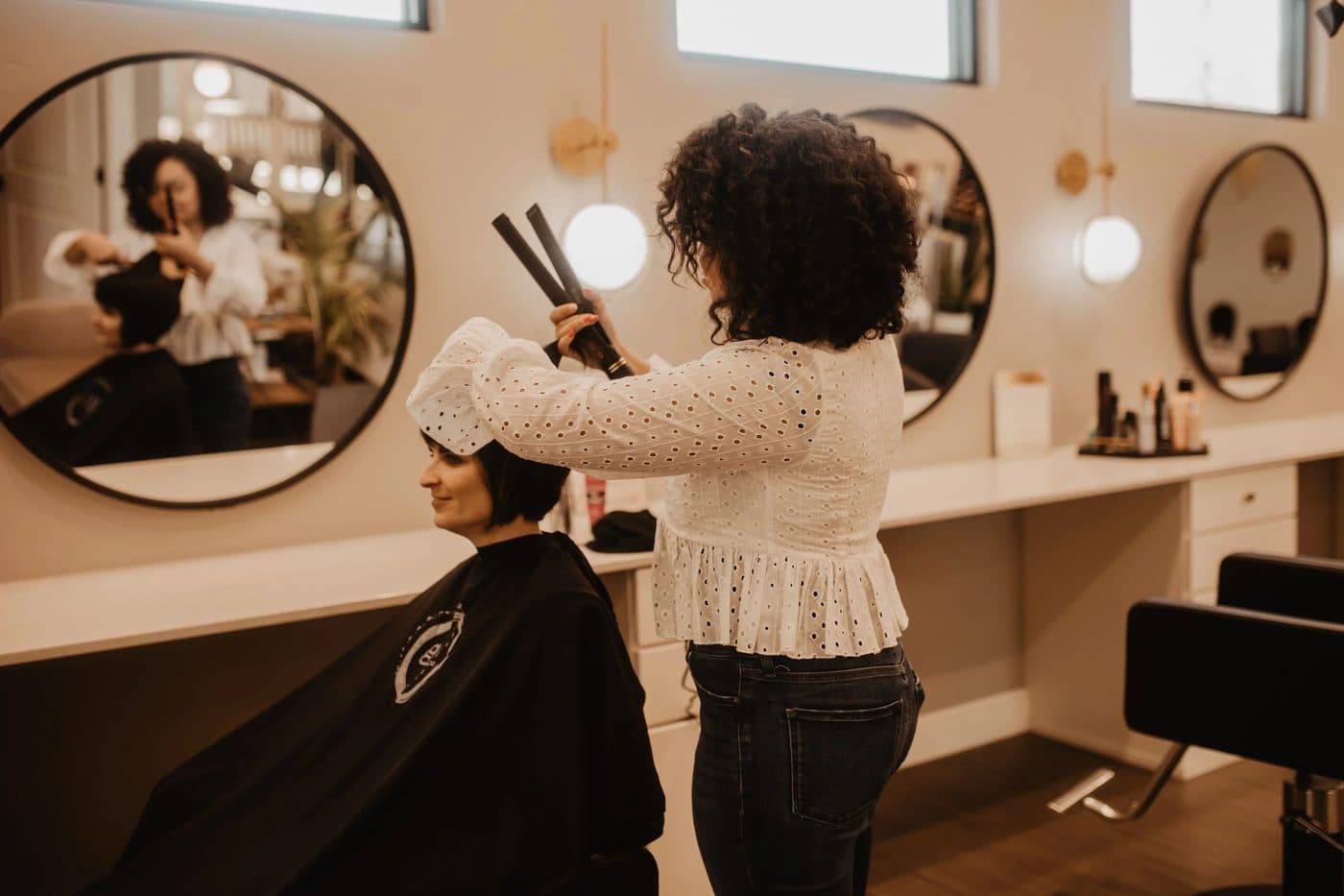 Hair stylist working with a client in a modern salon